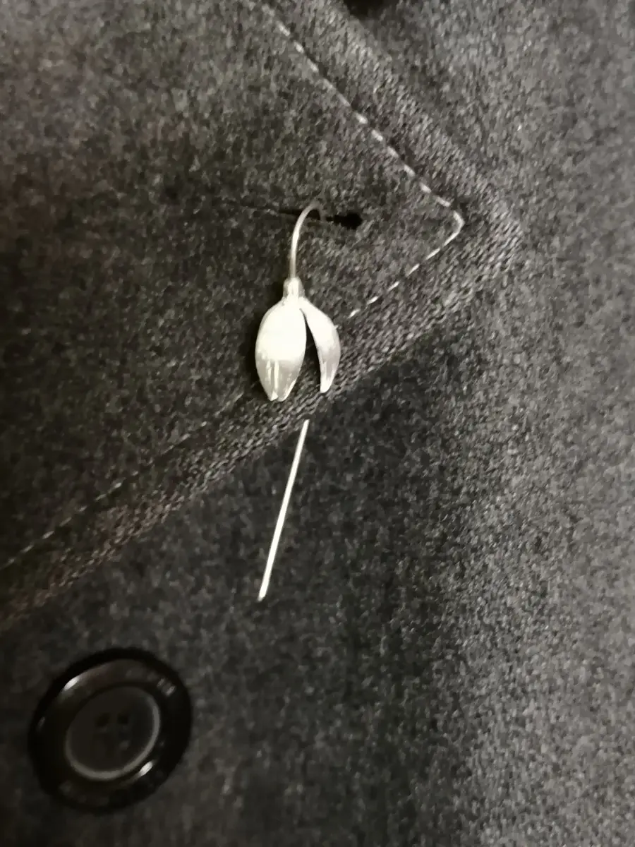 Silver Snowdrop Lapel Pin on a Grey Coat